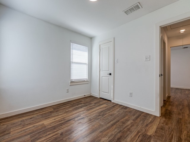 empty room featuring dark hardwood / wood-style flooring