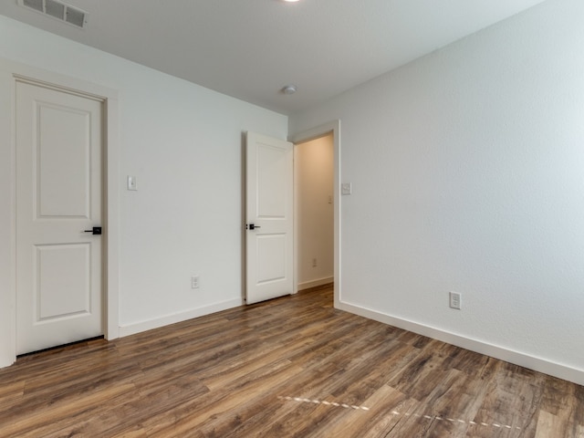 unfurnished room featuring dark hardwood / wood-style flooring