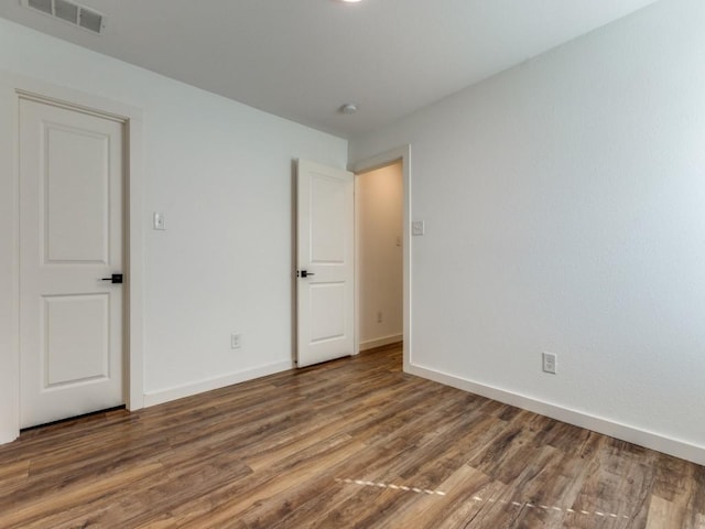 723 E Maple Row, Denison, TX 75021 - unfurnished bedroom featuring wood finished floors and baseboards