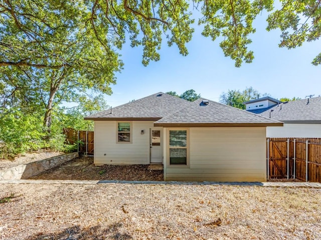 723 E Maple Row, Denison, TX 75021 - rear view of house featuring a shingled roof and a fenced backyard