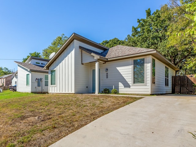 rear view of house with a yard