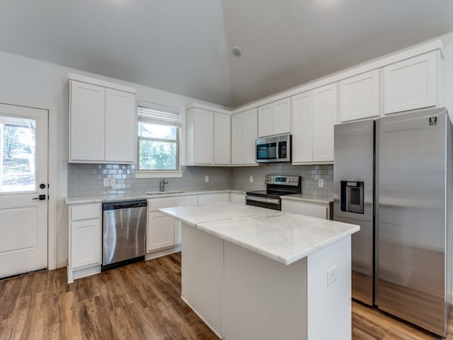 kitchen featuring white cabinetry, a center island, stainless steel appliances, and sink