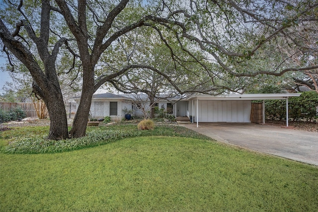 single story home featuring a carport, a front yard, and a garage