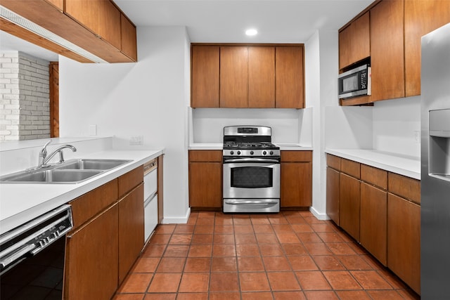 kitchen featuring stainless steel appliances, tile patterned flooring, sink, and tasteful backsplash