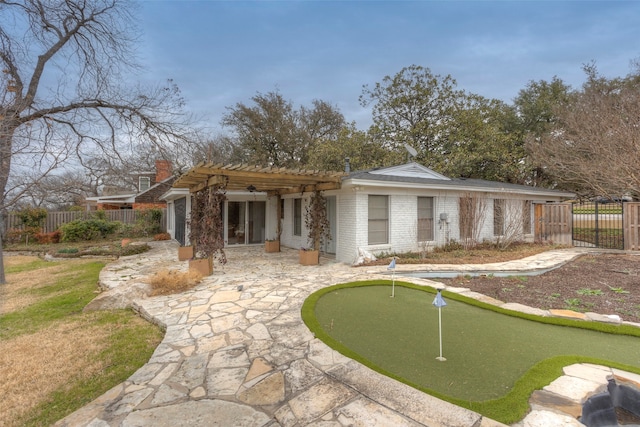 rear view of property featuring a pergola and a patio