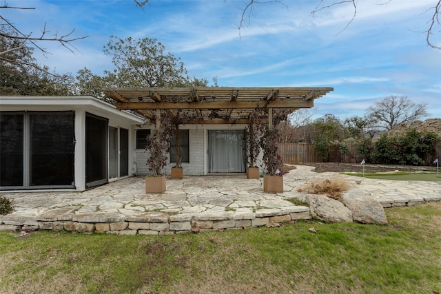 back of house with a patio, a pergola, a lawn, and a sunroom