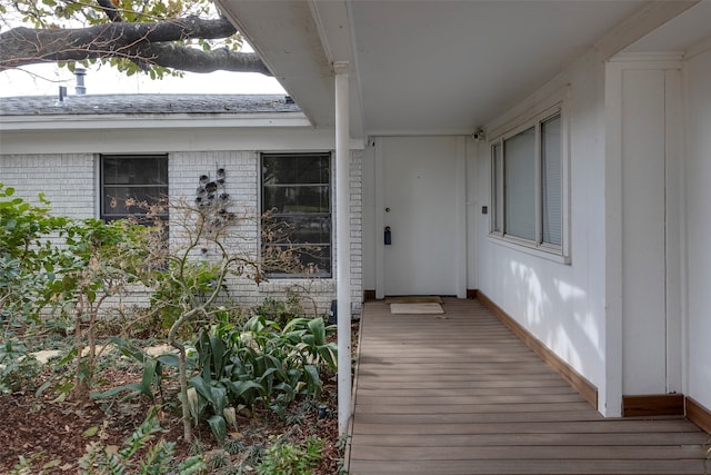 view of exterior entry with a wooden deck