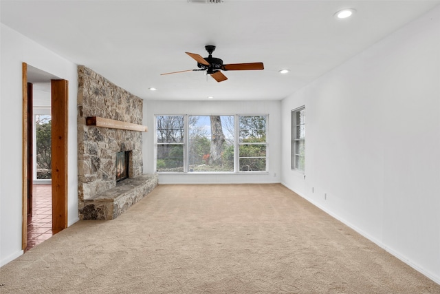 unfurnished living room featuring carpet, ceiling fan, and a fireplace