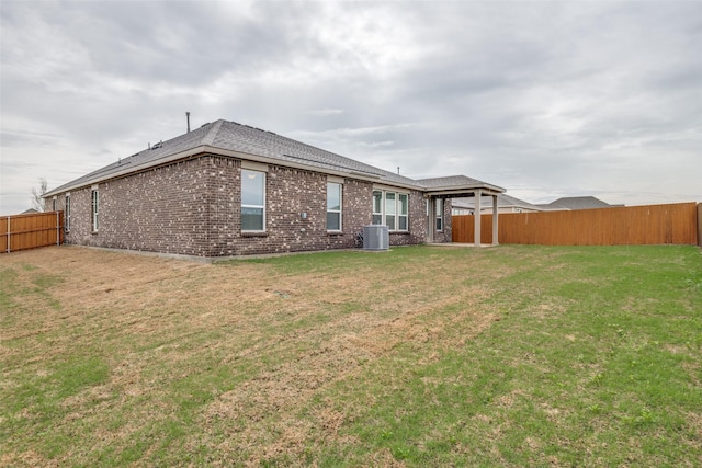 3725 Blooming Prairie Dr, Crandall, TX 75114 - back of house featuring cooling unit, a fenced backyard, brick siding, and a yard