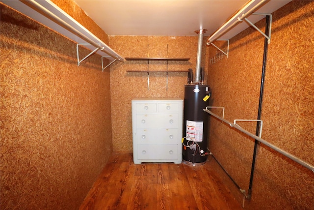 spacious closet with wood-type flooring and gas water heater