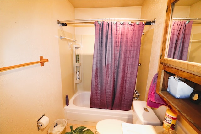 bathroom featuring toilet and shower / bath combination with curtain