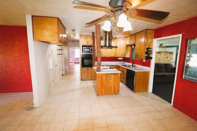 kitchen featuring ceiling fan, a kitchen island, island range hood, black appliances, and sink