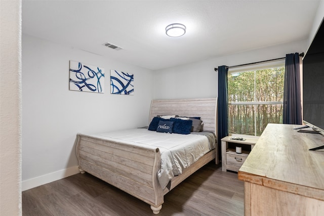 bedroom featuring dark hardwood / wood-style flooring