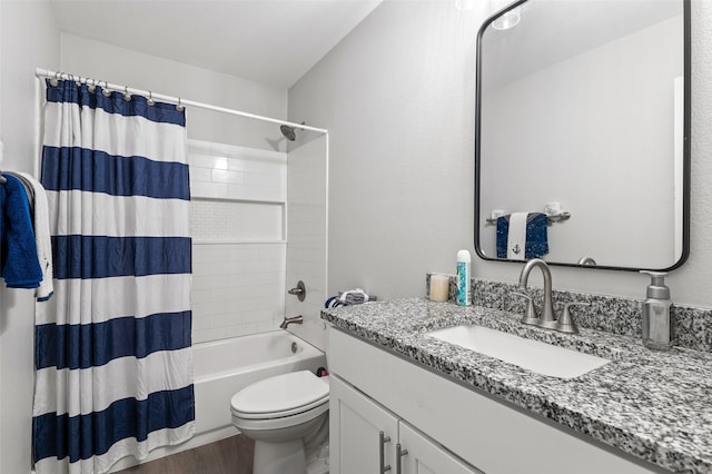 full bathroom with hardwood / wood-style floors, vanity, shower / bath combo with shower curtain, and toilet