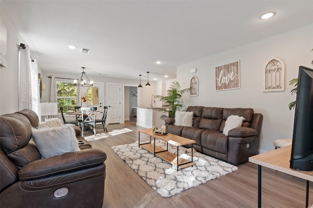 living room with a chandelier and hardwood / wood-style flooring