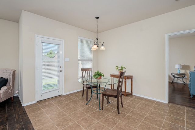 dining area featuring light wood-type flooring and a notable chandelier