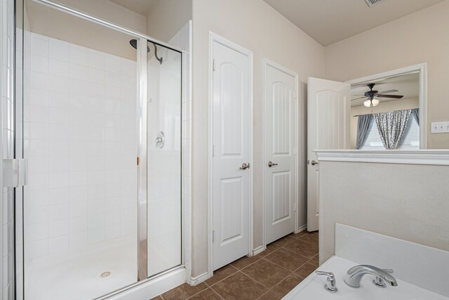 bathroom with tile patterned flooring, ceiling fan, and plus walk in shower