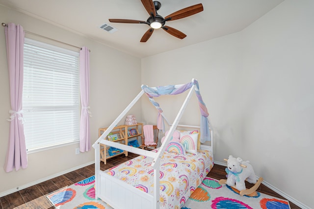 bedroom featuring dark hardwood / wood-style flooring and ceiling fan