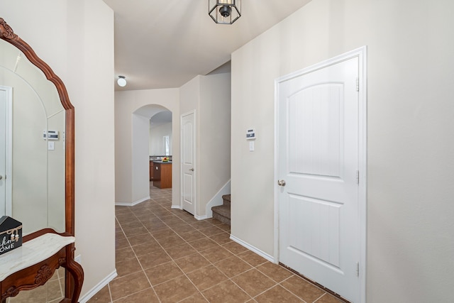 hallway with dark tile patterned floors