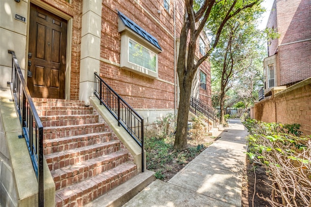 entrance to property featuring brick siding