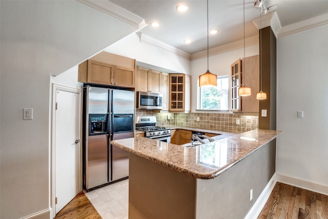 kitchen with kitchen peninsula, decorative light fixtures, backsplash, appliances with stainless steel finishes, and light stone countertops