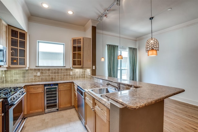 kitchen featuring stainless steel appliances, wine cooler, a sink, and decorative backsplash