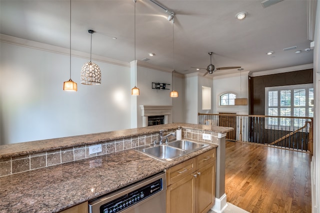 kitchen with hanging light fixtures, light hardwood / wood-style floors, ceiling fan, stainless steel dishwasher, and sink