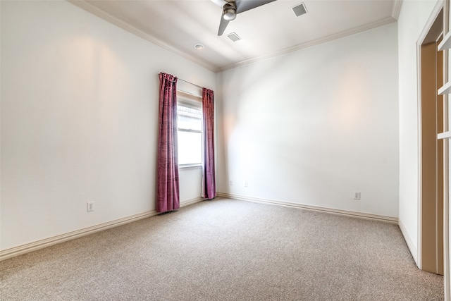 spare room with crown molding, carpet flooring, and ceiling fan