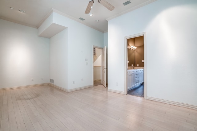 unfurnished bedroom featuring ceiling fan, light wood-type flooring, ensuite bath, and ornamental molding