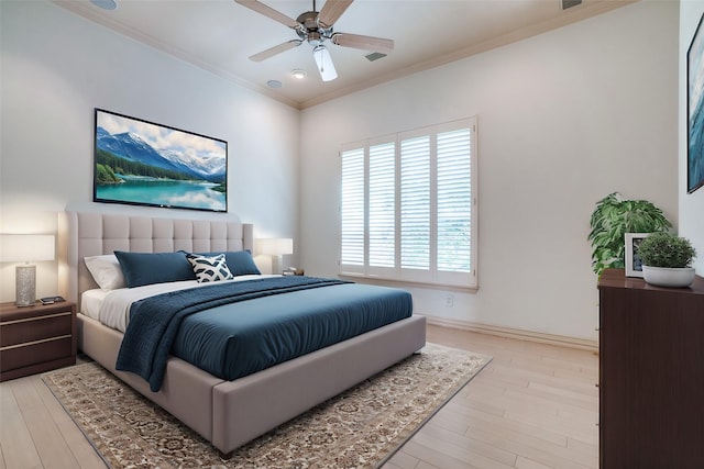 bedroom featuring a ceiling fan, baseboards, crown molding, and light wood finished floors