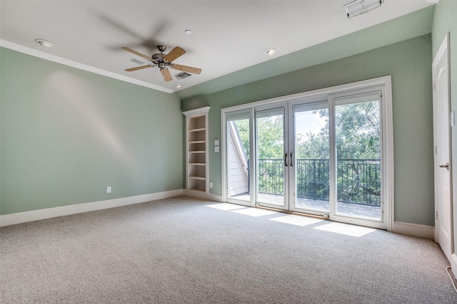 carpeted spare room featuring ornamental molding, visible vents, and baseboards