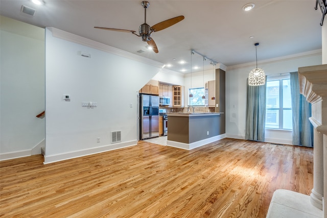 kitchen featuring appliances with stainless steel finishes, kitchen peninsula, ceiling fan, light hardwood / wood-style flooring, and ornamental molding