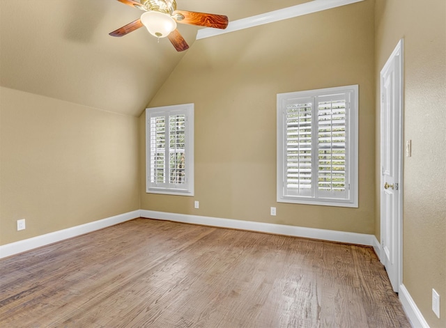 unfurnished room with vaulted ceiling, ceiling fan, and light hardwood / wood-style flooring