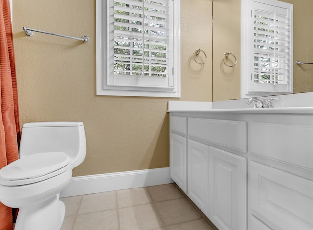 bathroom with tile patterned floors, vanity, and toilet