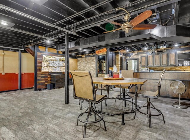 basement with a ceiling fan and wood finished floors
