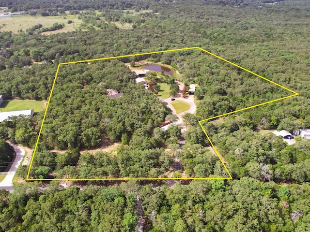 drone / aerial view featuring a wooded view
