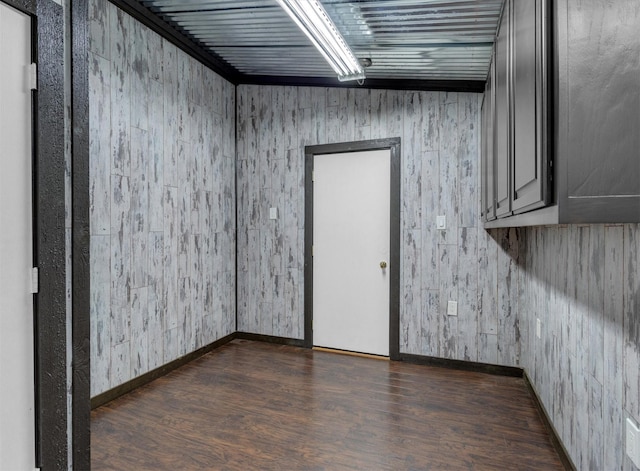 unfurnished room featuring baseboards and wood finished floors