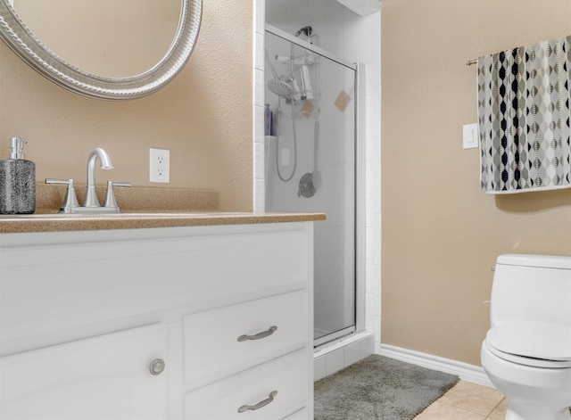 bathroom with vanity, toilet, an enclosed shower, and tile patterned floors