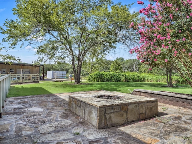 view of patio with an outdoor fire pit and fence