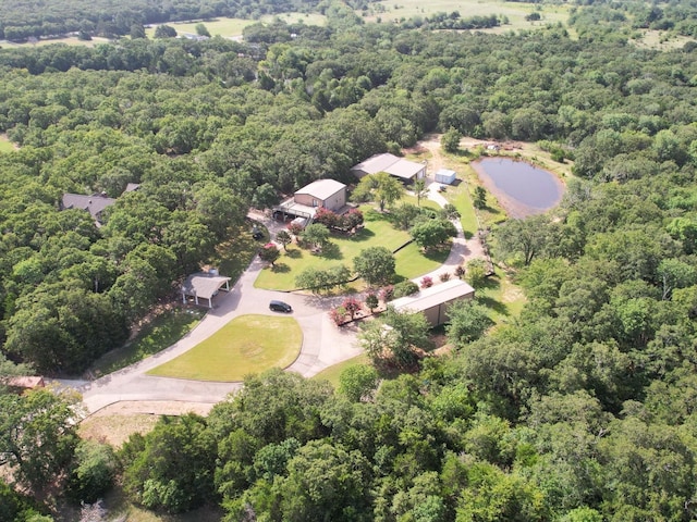 birds eye view of property with a forest view