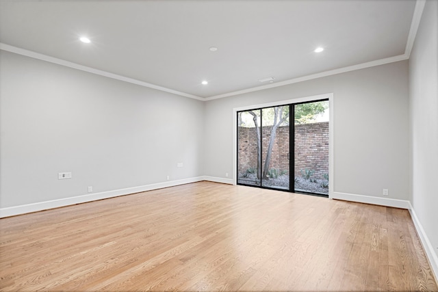 spare room with light hardwood / wood-style flooring and crown molding