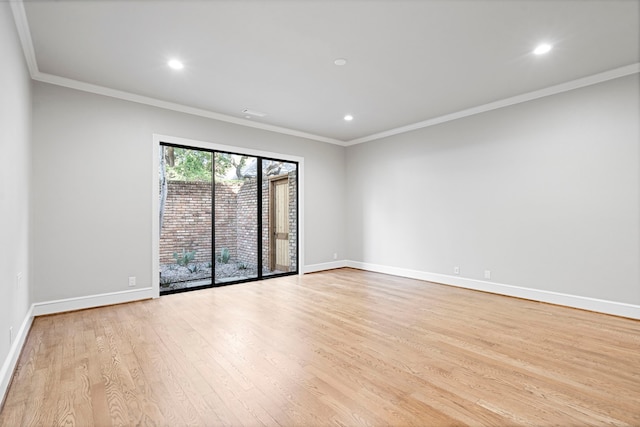 empty room with ornamental molding and light hardwood / wood-style floors