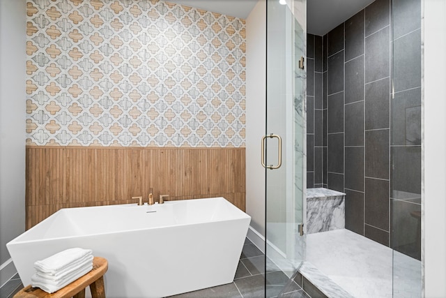 bathroom featuring wooden walls, separate shower and tub, and tile patterned floors