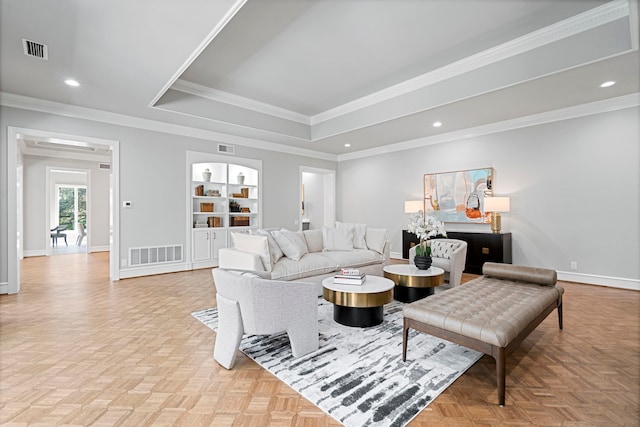 living room with light parquet flooring, crown molding, and built in features