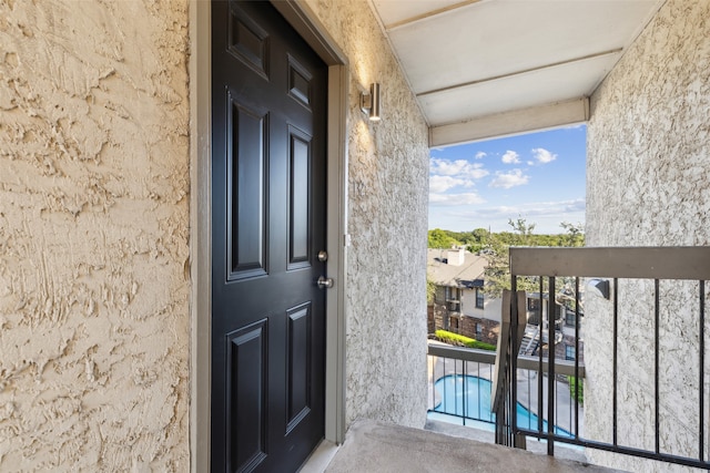 entrance to property featuring a balcony