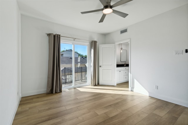 spare room with ceiling fan and light wood-type flooring