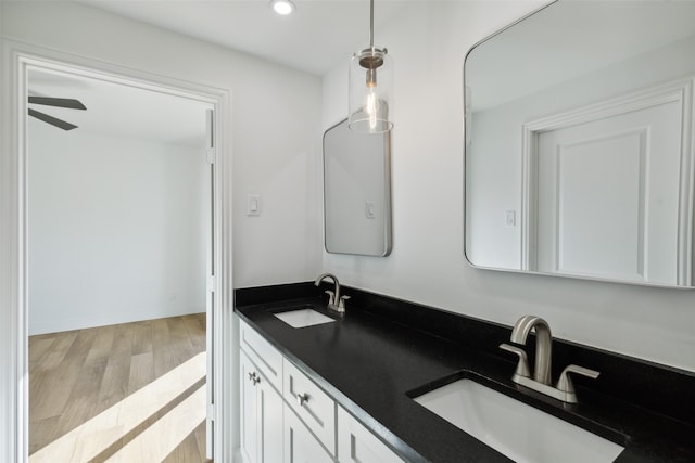 bathroom featuring ceiling fan, hardwood / wood-style flooring, and vanity