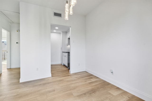 spare room with light wood-type flooring