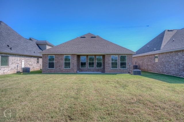 rear view of house featuring a patio and a lawn