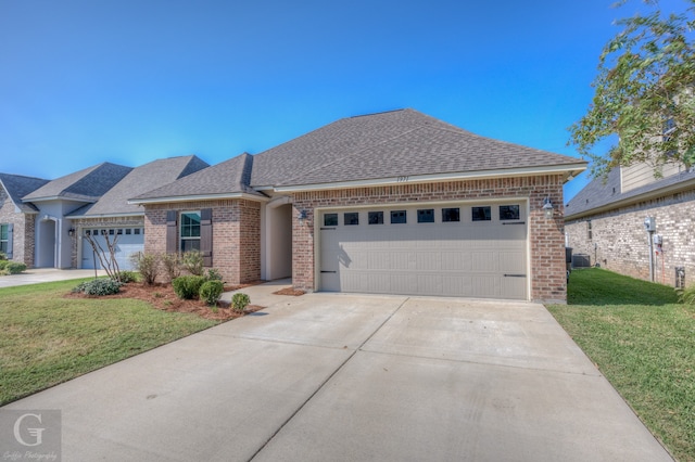 view of front facade with a garage and a front lawn